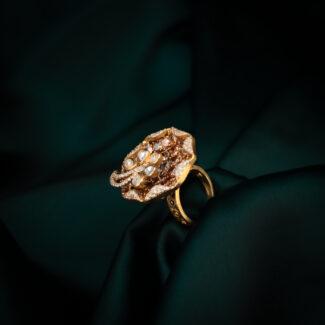 Elegant gold ring on dark fabric