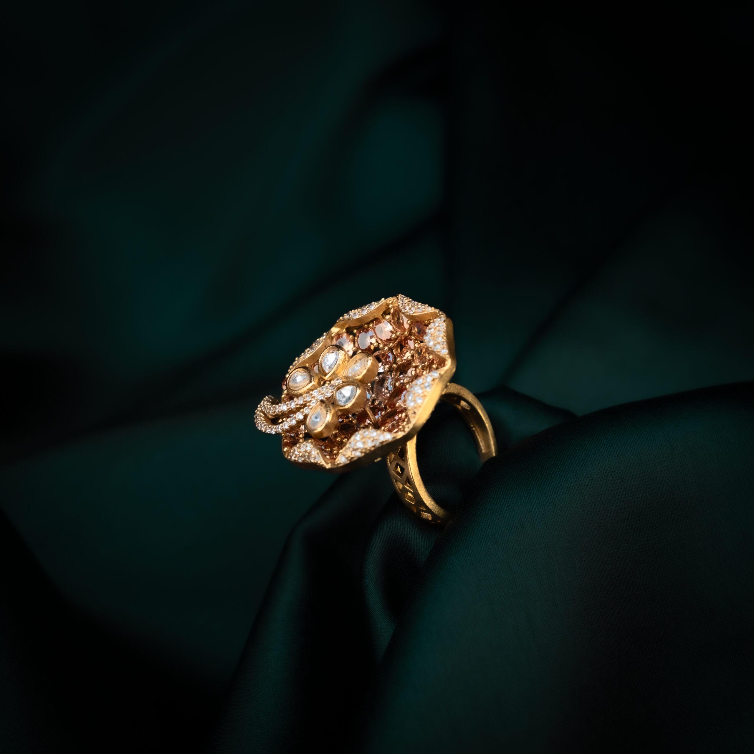 Elegant gold ring on dark fabric